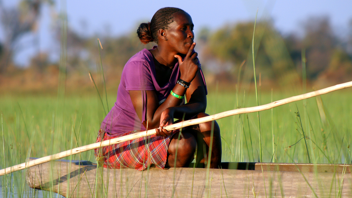 Poler in the Okavango Delta, Botswana, watches as her companions move into the wilderness. Other images: